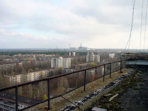 The abandoned city of Pripyat with the Chernobyl plant in the distance