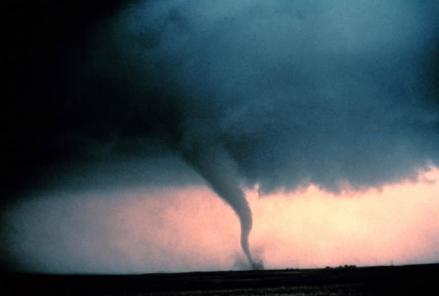 Tornado with dust and debris cloud forming at the surface